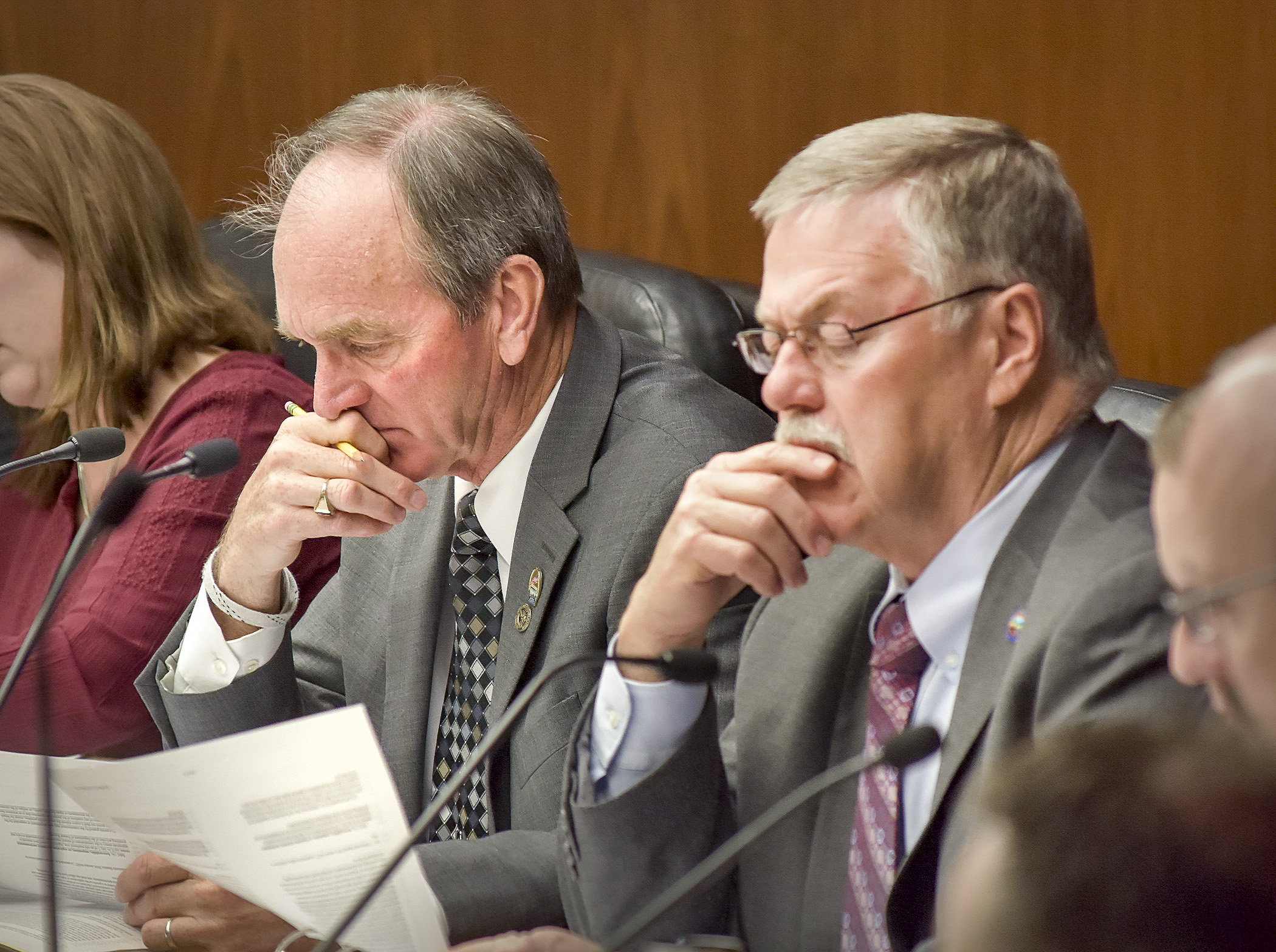 Rep. Dan Fabian, left, and Sen. Bill Ingebrigtsen, co-chairs of the omnibus environment and natural resources finance conference committee, follow along during a walk-through of the side-by-side and spreadsheet comparisons April 19. Photo by Andrew VonBank